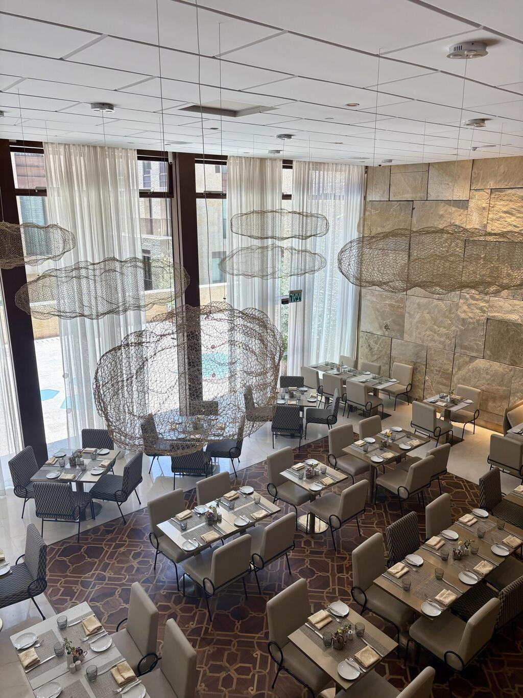 חדר האוכל. רצפה עשויה עץ משולב וגופי תאורה מרחפים מעל (צילום: יוליה פריליק-ניב) מלון תיאטרון ירושלים