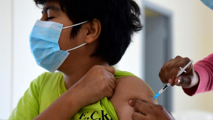 נער מקבל חיסון לקורונה בפרגוואי