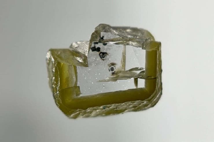 הכתמים האפורים הזעירים של המינרל בתוך היהלום שנמצא בבוטסואנה