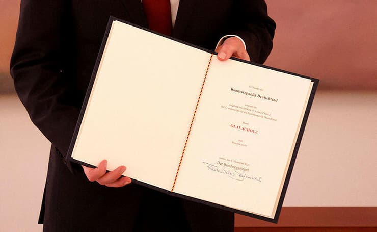 קנצלר גרמניה החדש אולף שולץ עם כתב המינוי אחרי שנבחר על ידי חברי הפרלמנט לתפקיד