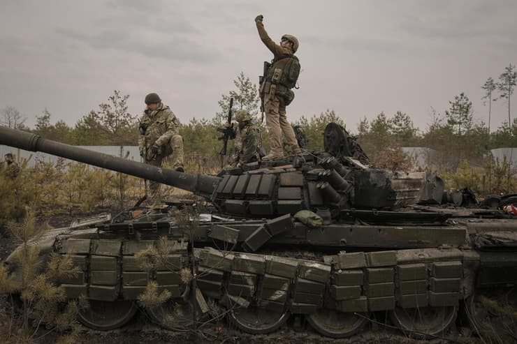 חייל אוקראיני מצלם סלפי על טנק רוסי