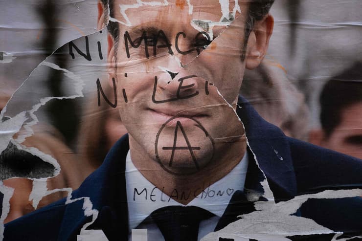 כרזת בחירות של נשיא צרפת עמנואל מקרון שהושחתה ב פריז עם השם של מלנשון