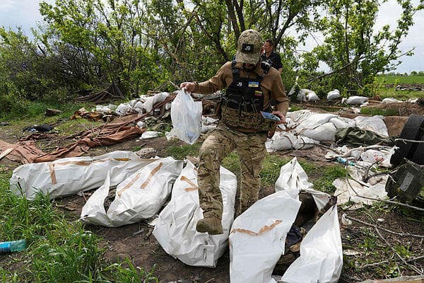 אוקראינה חייל אוקראיני חילוץ שרידי גופות של חיילים רוסים בכפר ליד חרקוב