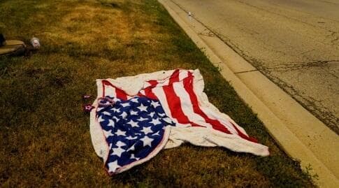 דגל ארה"ב נטוש על מסלול המצעד בזירת הרצח