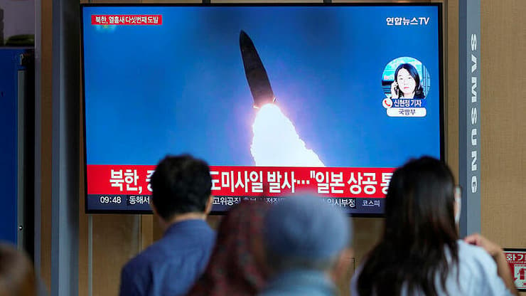 יפנים צופים בדיווחים אודות שיגור הטיל של צפון קוריאה שחלף מעל יפן