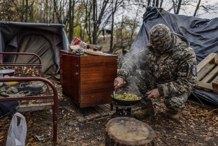 אוקראינה חייל אוקראיני מבשל ב עמדה צבאית ב צפון מחוז חרסון מלחמה עם אוקראינה