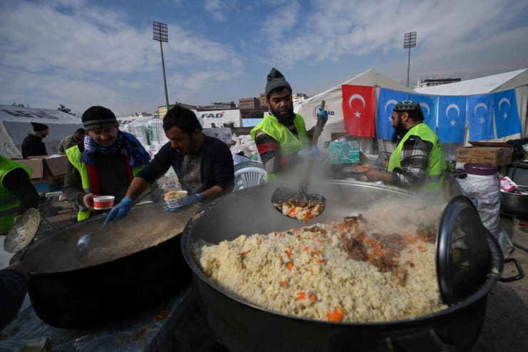 טורקיה מתנדבים מחלקים אוכל ל עקורים ב אצטדיון ב קרמנמרש רעידת אדמה