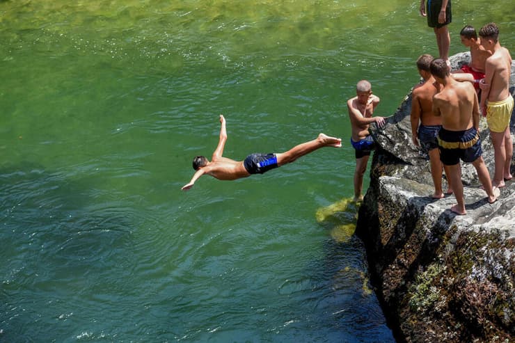 אירופה גל חום קרברוס מתקררים בנהר ליד סקופיה צפון מקדוניה