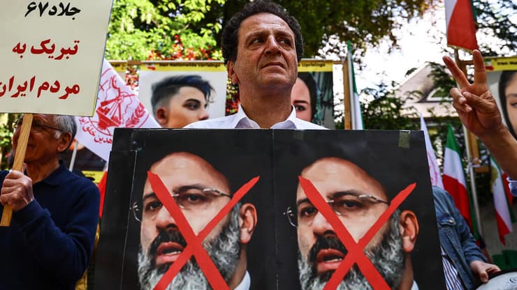 מתנגדי משטר איראני חוגגים את מותו של הנשיא איברהים ראיסי מול שגרירות איראן ב ברלין