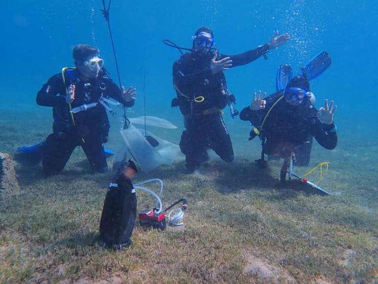 צוות המחקר עורך מדידות באמצעות תא מטבולי, שמדמה חשכה מעל עשב הים ימון הקשקשים במפרץ אילת