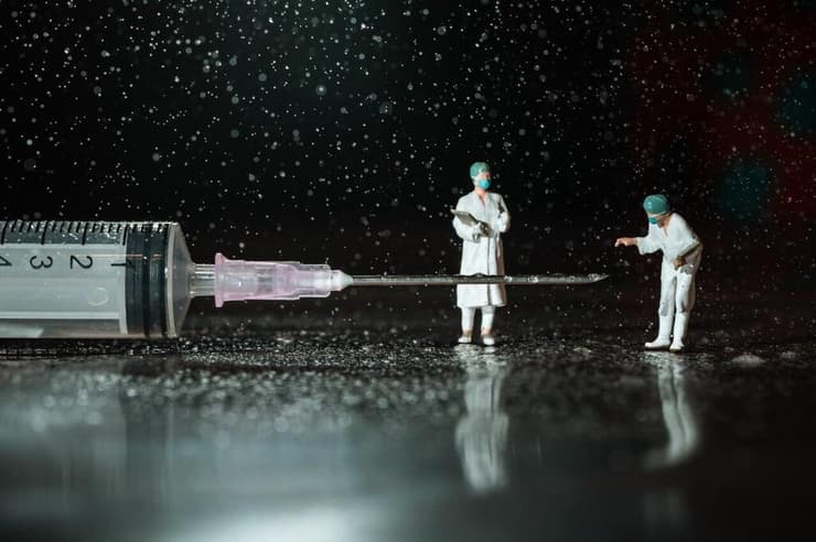 מזרק רפואי עם צוות רפואי מיניאטורי גיבורים קטנים, טיפולים גדולים