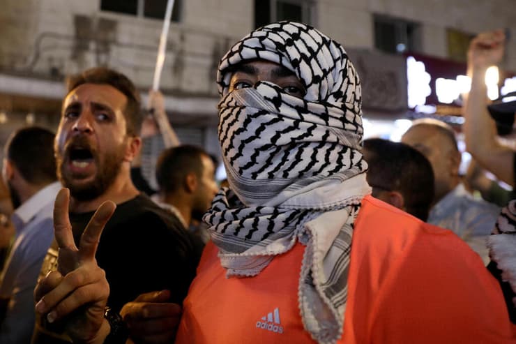 שלטי "מוות לישראל" בחגיגות הפיגוע בעמאן, ירדן