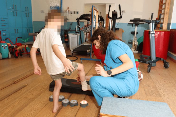 הפיזיותרפיסטית נרימאן גטאס ואחד הילדים המטופלים בשיקום ברמב"ם