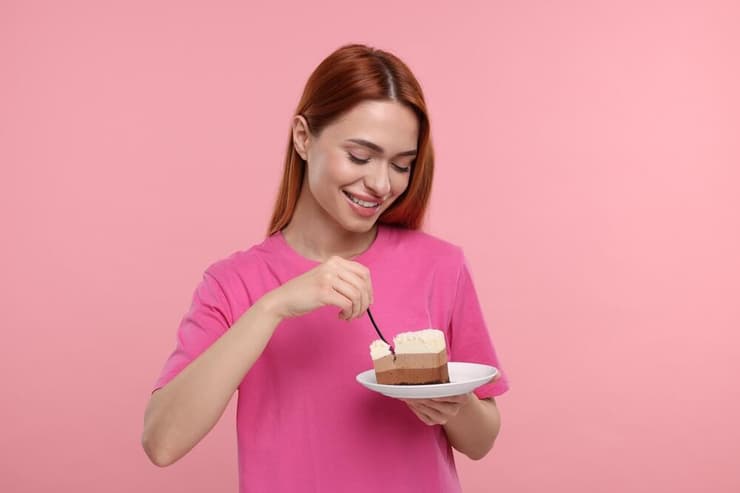 אישה אוכלת מתוק עוגה