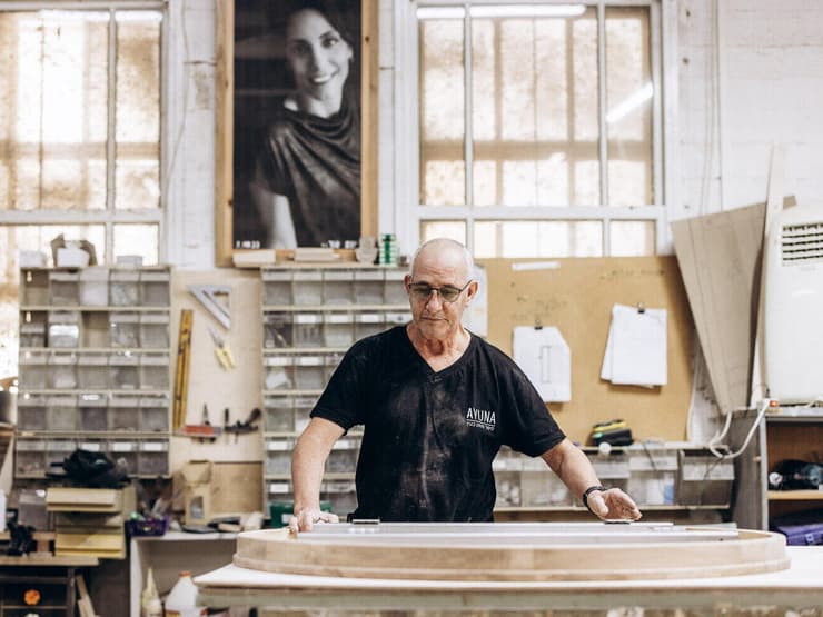 תמונתה של יונת אור, שהקימה את הנגרייה ונרצחה ב-7/10, משקיפה מעל תהליך הייצור yk14123297