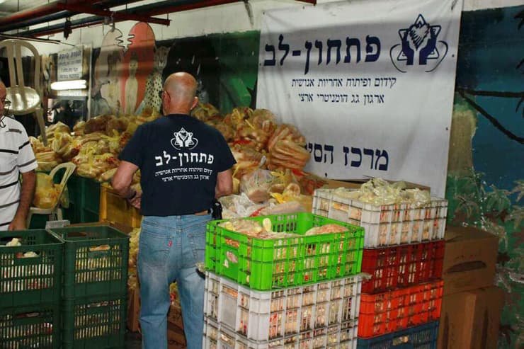 מתנדבי ארגון "פתחון לב" מכינים סלי מזון למקבלי הסיוע