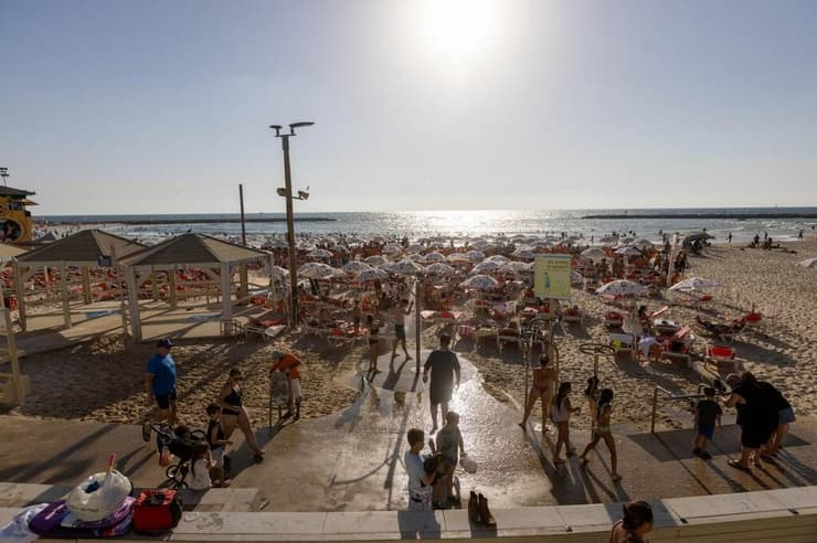 צילום: טל שחר מתרחצים בחוף היום בתל אביב