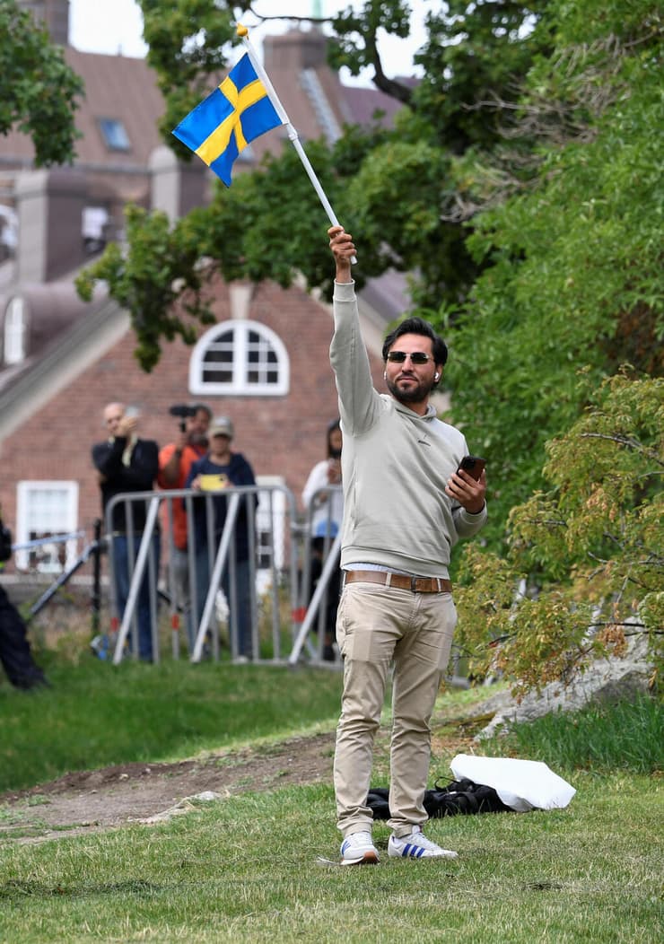 מומיקה מניף את דגל שבדיה לפני שריפת הקוראן מול שגרירות עיראק בשטוקהולם (צילום: רויטרס, TT News Agency/Caisa Rasmussen) שבדיה הפגנה שטוקהולם מול שגרירות עיראק סלוואן מומיקה מבקש מקלט עיראקי בא לבזות את הקוראן