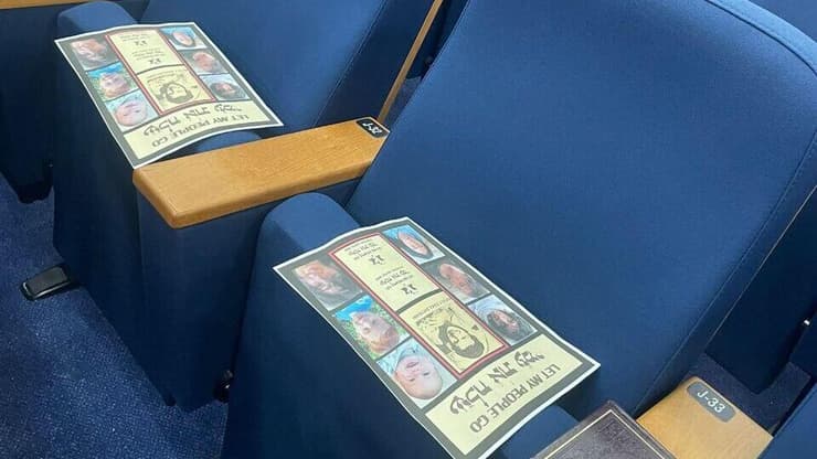 עלונים שחולקו בבית הכנסת ועליהם פני חטופים וחטופות עם הכיתוב "שלח את עמי"