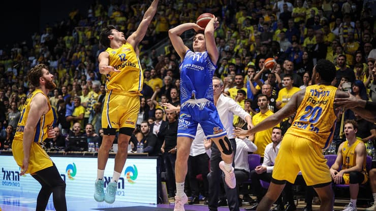 שחקן מכבי ר"ג אדם אריאל מול שחקן מכבי ת"א ג'ון דיברתולומיאו, וויל ריימן, ליוואי רנדולף