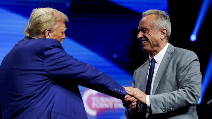 Robert F. Kennedy Jr. and Republican presidential candidate and former U.S. President Donald Trump greet each other at a campaign event sponsored by conservative group Turning Point USA, in Duluth, Georgia, U.S., October 23, 2024