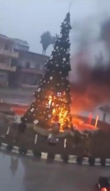 "אובזקים, או צ'צ'נים". תיעוד ההצתה מאזור חמה שעורר זעם הצתת עץ חג מולג בעיירה נוצרית באזור חמה סוריה בתקרית שעוררה זעם מצד' נוצרים במדינה