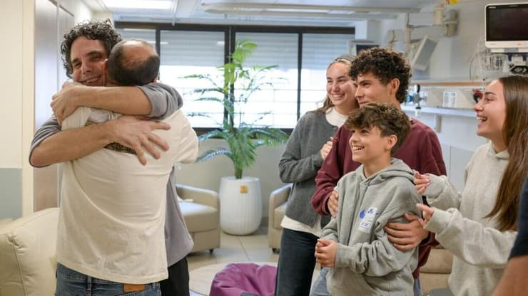 החיבוק של האחים קלדרון, כשלצידם ילדיו של עופר (צילום: מעיין טואף / לע"מ) עופר קלדרון עם אחיו וילדיו בבית החולים שיבא