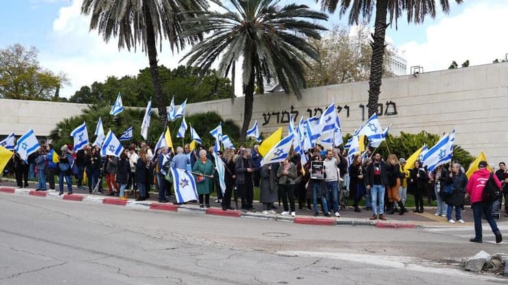 מצדיעים לחטופים ברחובות (צילום: נבט כהנא) אזרחים תושבי רחובות ליד מכון ויצמן עם דגלי ישראל לאות תמיכה עם חזרת החטופים המתים