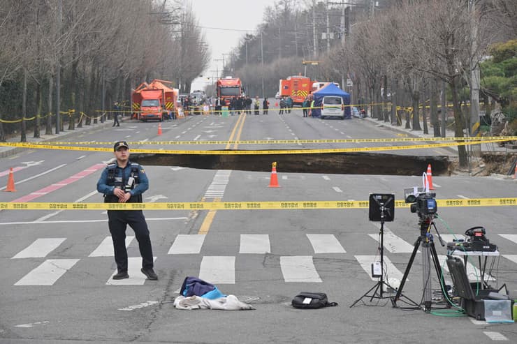 צילום: Anthony WALLACE / AFP בולען ענקי שנפער ב כביש ב סיאול ב דרום קוריאה ואליו נפל אופנוען שנהרג