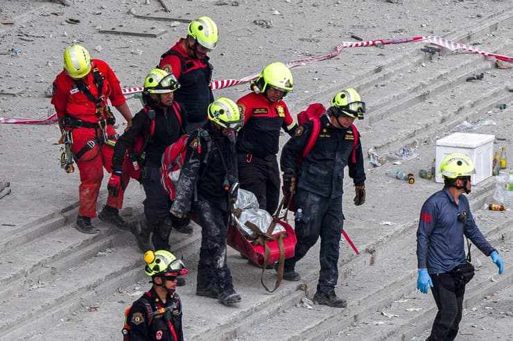 פינוי גופה שאותרה היום בהריסות המגדל בבנגקוק (צילום: Chanakarn LAOSARAKHAM / AFP) תאילנד בנגקוק פינוי גופה זירת קריסת בניין פועלים רעידת אדמה רעש
