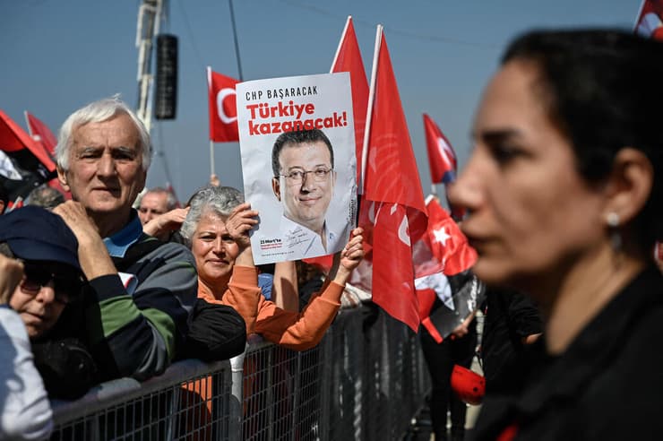 מפגינים בטורקיה עם תמונתו של אקרם אימאמאולו ראש עיריית איסטנבול (צילום: KEMAL ASLAN/AFP) מפגינים בטורקיה עם תמונתו של אקרם אימאמאולו ראש עיריית איסטנבול