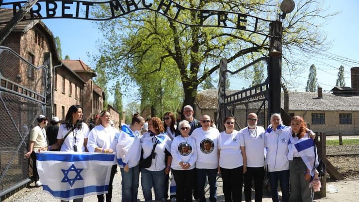 משלחת שורדי השבי ובני משפחות חטופים בכניסה לאושוויץ (צילום: אלינור ללוש רותם/קרן מנומדין) משלחת שורדי השבי ומשפחות החטופים שהגיעו למצעד החיים באושוויץ