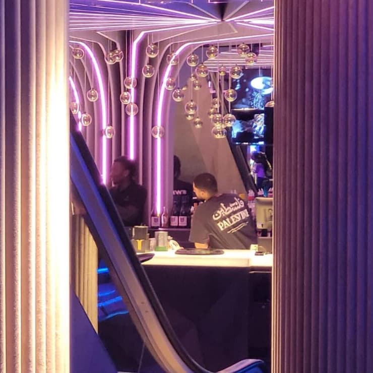 אחד העובדים עם חולצה ועליה הכיתוב "פלסטין"