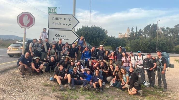 חניכי מכינת תבור על רקע שלט הכניסה לקריית שמונה (צילום: באדיבות מכינת תבור) חניכי תבור על רקע שלט הכניסה לקריית שמונה