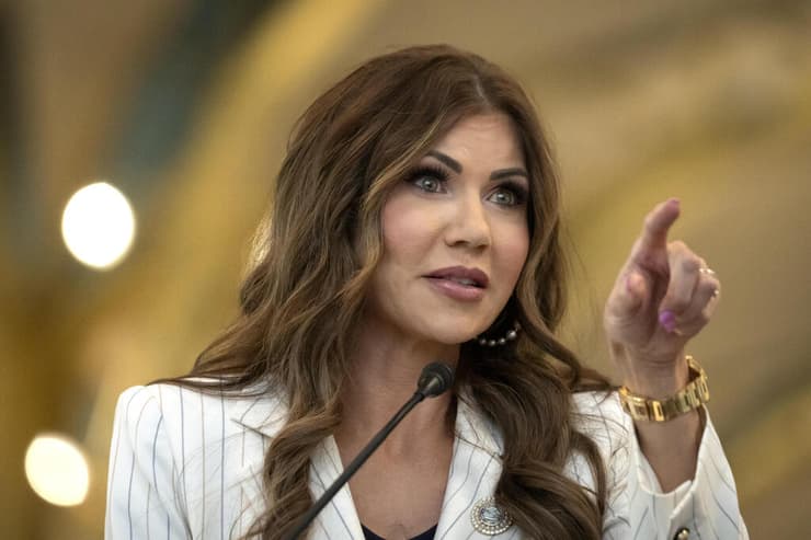 שרת ביטחון המולדת קריסטי נואם מכריזה על סיום נוהל חליצת הנעליים