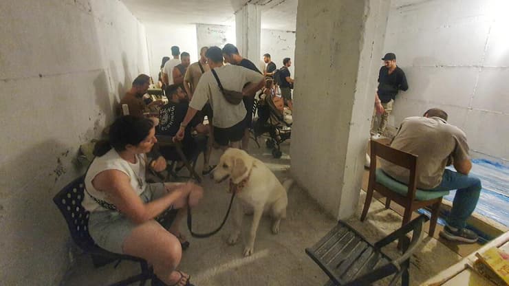 אנשים במקלט באזור כיכר רבין, הערב (צילום: דנה קופל ) אנשים במקלט באזור כיכר רבין בזמן שיגור טיל מתימן