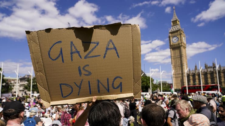 "עזה גוססת". הפגנה בלב לונדון (צילום: Abodunde/Getty Images, AP Photo/Alberto Pezzali) הפגנה פרו פלסטינית בכיכר הפרלמנט בלונדון, בריטניה