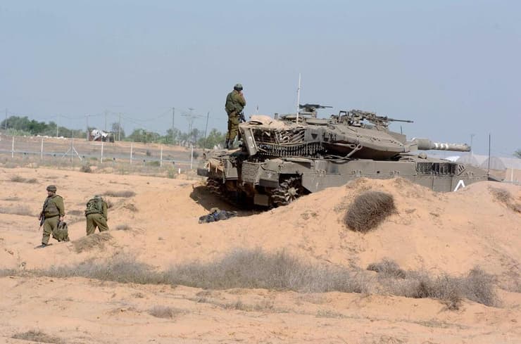 הטנק של גלעד שליט אחרי החטיפה. משמאל: יואב בונה מחזיק בשכפ"ץ של גלעד