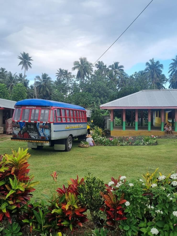 נוף סמואי טיפוסי. גינה ירוקה ומטופחת לצד אוטובוס צבעוני