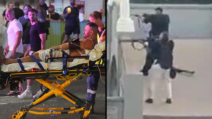 המחבלים בסידני, ופינוי אחד הפצועים (צילום: AP Photo/Mark Baker) פינוי הפצועים בירי ההמוני בבונדיי ביץ' באוסטרליה