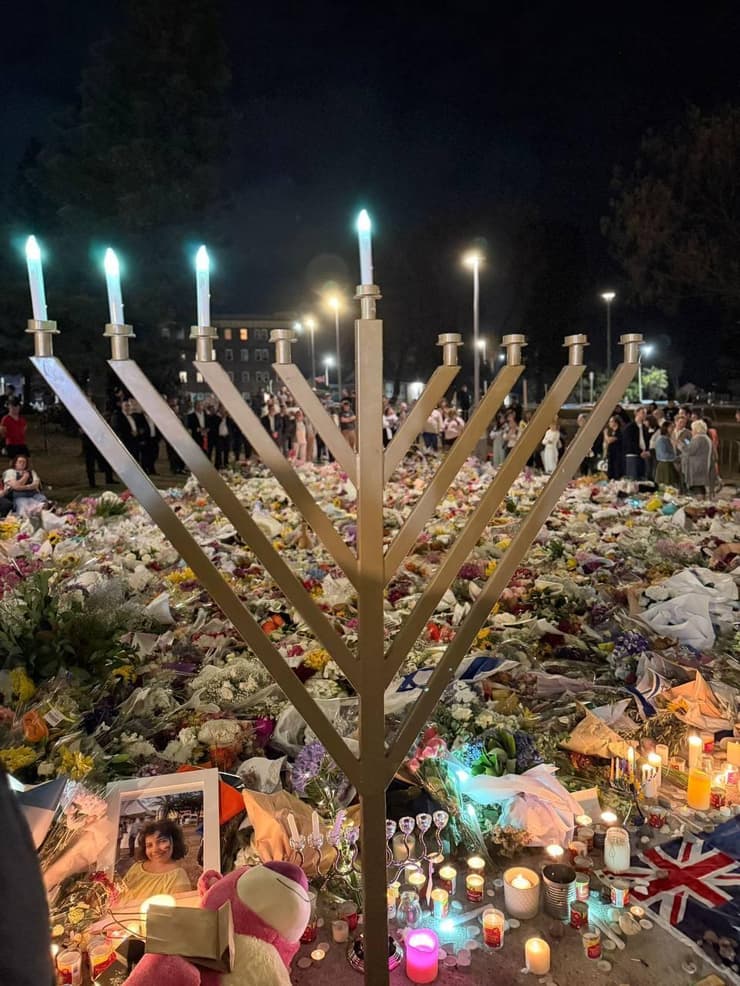 צילום: סעיף 27א לפי חוק זכויות יוצרים זרים ונרות הונחו במקום הפיגוע בבונדיי ביץ'