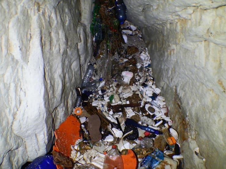 שובל של פריטי פלסטיק במערות הים בקפריסין (צילום: Ioannis Savva) שובל של פריטי פלסטיק במערות הים בקפריסין