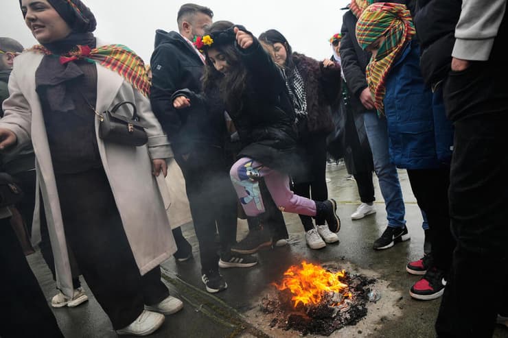 ילדה קופצת מעל אש בחגיגות הנורוז באיסטנבול (צילום: AP Photo / Khalil Hamra) ילדה קופצת מעל אש בנורוז באיסטנבול