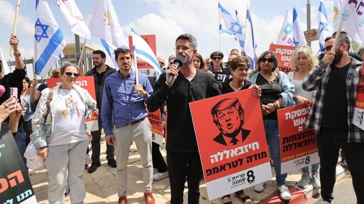 ראש העיר שטרן עם השלט: "חיזבאללה מודה לטראמפ" (צילום: אלכס קולומויסקי) מחאת תושבי קריית שמונה מול משרד רה"מ