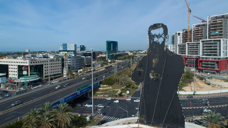 התמונה האיקונית של הרצל בצומת הסירה כשברקע אזור התעסוקה