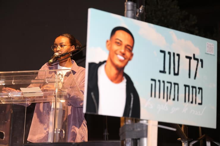 האחות יירוס על רקע תמונתו של ימנו ז"ל (צילום: יריב כץ) עצרת מחאה בהובלת משפחתו של בנימין ימנו זלקה ז"ל