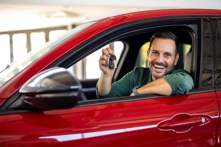 אדם יושב ברכב חדש ומחזיק מפתחות (קרדיט: Shutterstock) אדם יושב ברכב חדש ומחזיק מפתחות