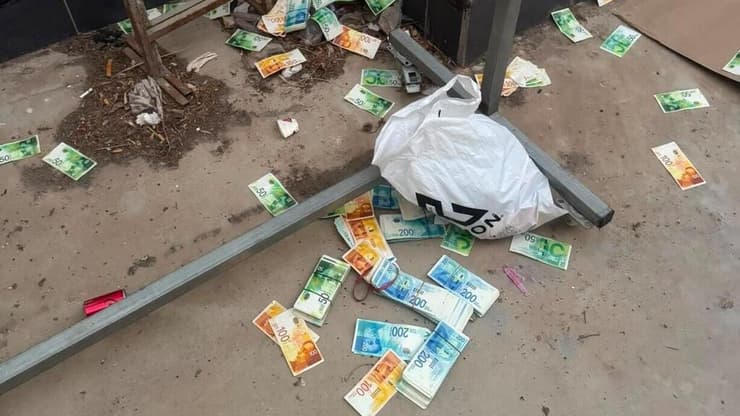 "אסור להחזיק כזה סכום במזומן בבית". חלק מהכסף המפוזר בריינה (צילום: באדיבות דוברות מחוז צפון) הכסף המפוזר בריינה