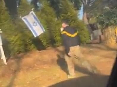 זומר הולך לעבר הדגל (צילום: מתוך דף X של StopAntisemitism) זומר הולך לעבר הדגל