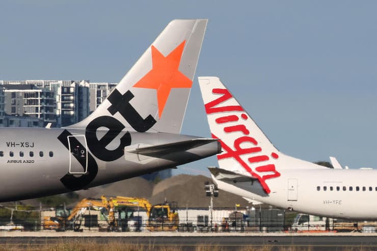 מטוס איירבוס A320 של ג'טסטאר חולף על פני מטוס של וירג'ין אוסטרליה בנמל התעופה בסידני (צילום: REUTERS/Hollie Adams) מטוס איירבוס A320 של ג'טסטאר חולף על פני מטוס של וירג'ין אוסטרליה בנמל התעופה בסידני